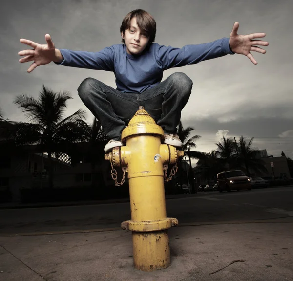 stock image Young boy on a fire hydrant