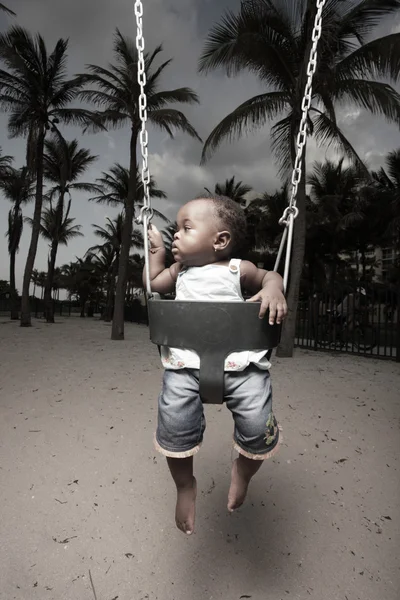 Young baby on a swing — Stock Photo, Image