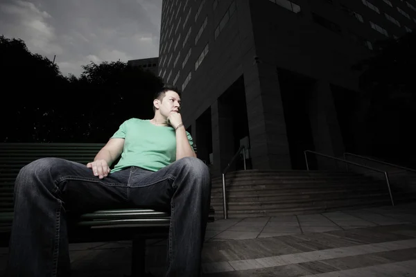 Мужчина сидит на скамейке — стоковое фото