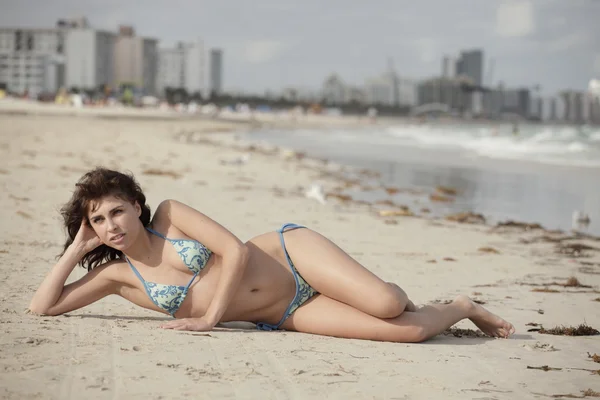 stock image Woman laying on the sand