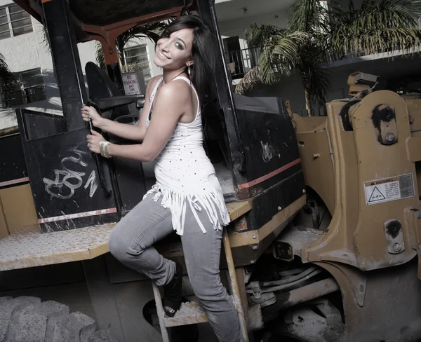 Frau posiert mit einer Baumaschine — Stockfoto