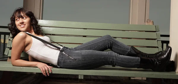 Woman laying on a bench Stock Image