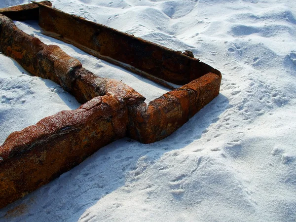 Rusted metal on the sand — Stock Photo, Image