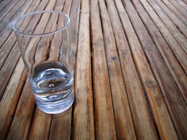 Glass on a wood table top clipart