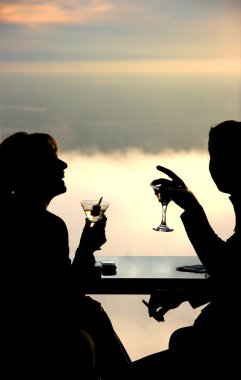 Couple having a drink in the sky clipart