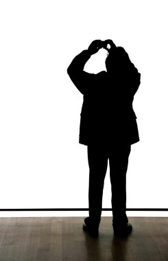 Silhouette of a man taking a picture clipart