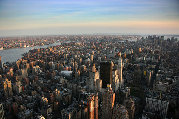 Aerial view over east lower Manhattan from Empire State building top, New York at sunset