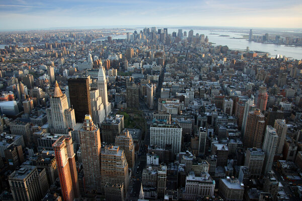 Aerial view over lower Manhattan from Empire State building top, New York at sunset