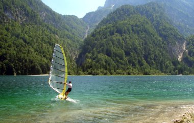 Windsurfer in a mountain lake clipart