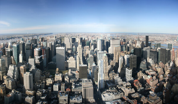 Aerial panoramic view over Manhattan from Empire State building top, New York. Sunny day, exceptional visibility, you could see far far away.