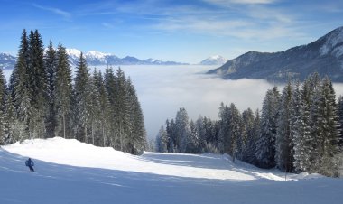 Skiing over the clouds panorama clipart