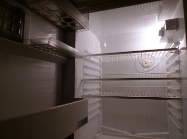 Empty fridge interior, side view clipart