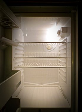 Empty fridge interior, frontal view clipart
