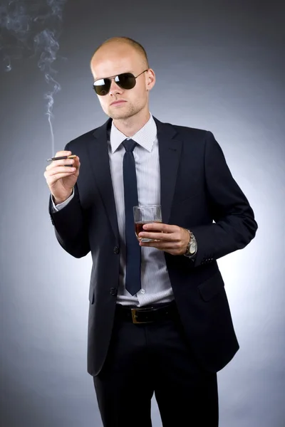 Businessman drinking and smoking — Stock Photo, Image
