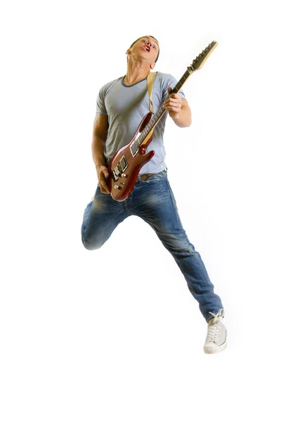 Passionate guitarist jumps in the air — Stock Photo, Image
