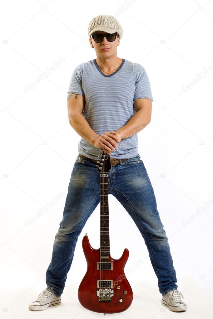Guitar between the legs of a guitarist