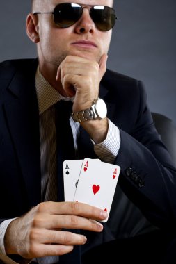 Businessman holding a poker hand clipart