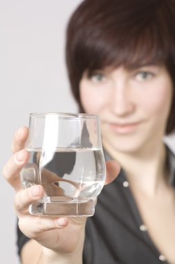 Young woman with glass of water clipart