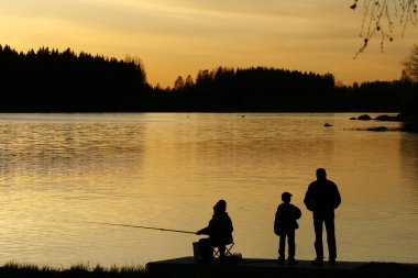 Fishing at sunset clipart