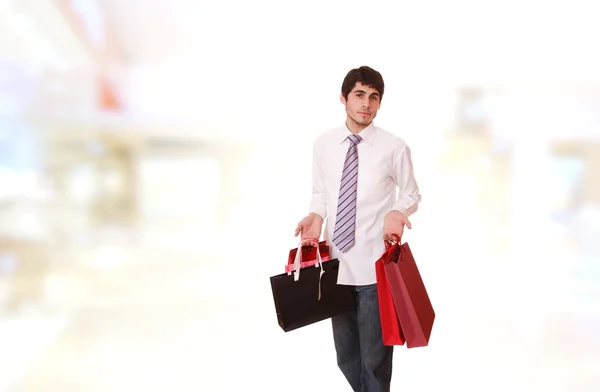 Bonito homem com sacos de compras — Fotografia de Stock