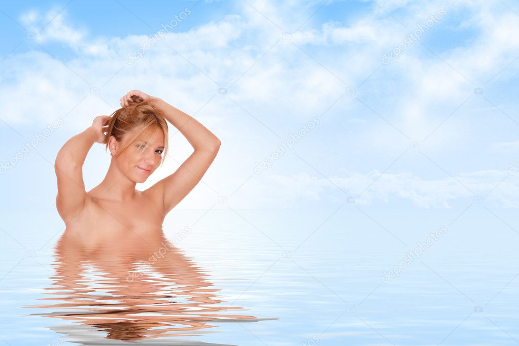 Young woman reflected in water