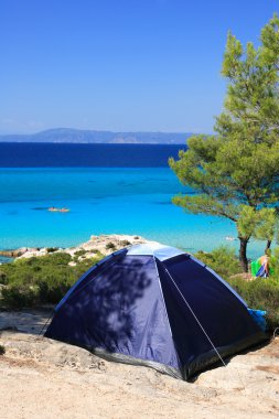 Lonely tent on a sandy beach clipart