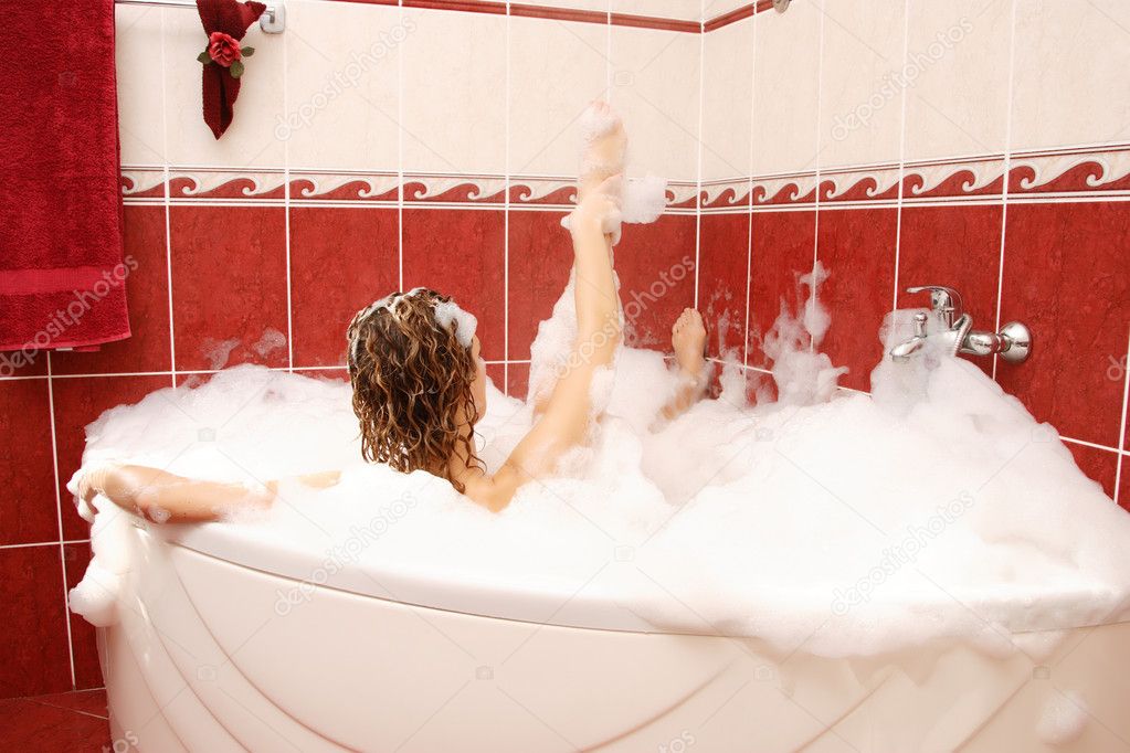 Young woman enjoys bath-foam
