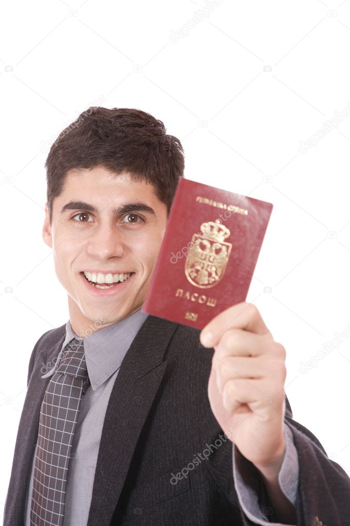 A businessman in a suit holds passport