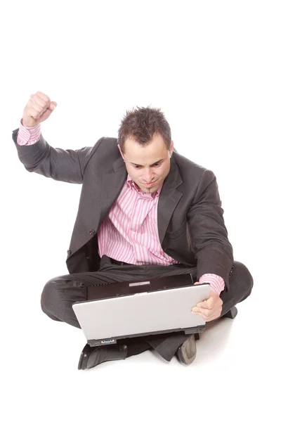 Young man with laptop sits on floor. — Stock Photo, Image