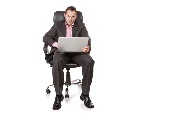 Relaxed young businessman, sitting on a chair. — Stock Photo, Image