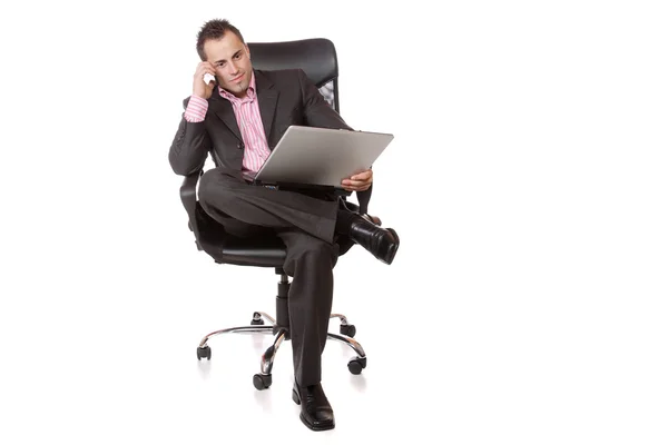 Relaxed young businessman, sitting on a chair. — Stock Photo, Image