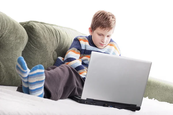 Cute young boy with laptop at home — Stock Photo, Image