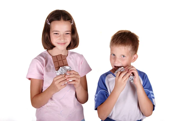Маленькие дети едят шоколад — стоковое фото