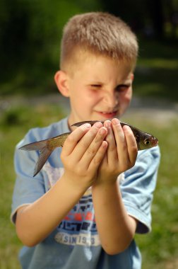 Child with fish clipart