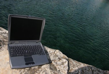 Laptop at the coast clipart