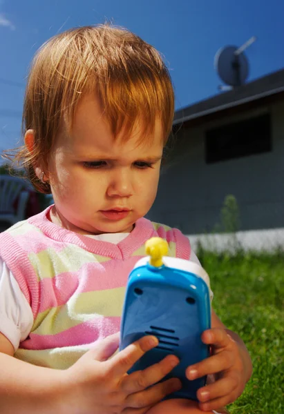 Young child with toy phone — Stock Photo, Image