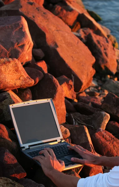 stock image Laptop among rocks
