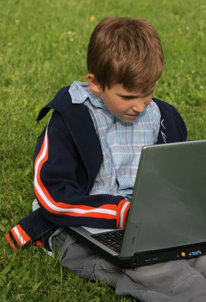 Young boy with notebook outdoor — Stock Photo, Image