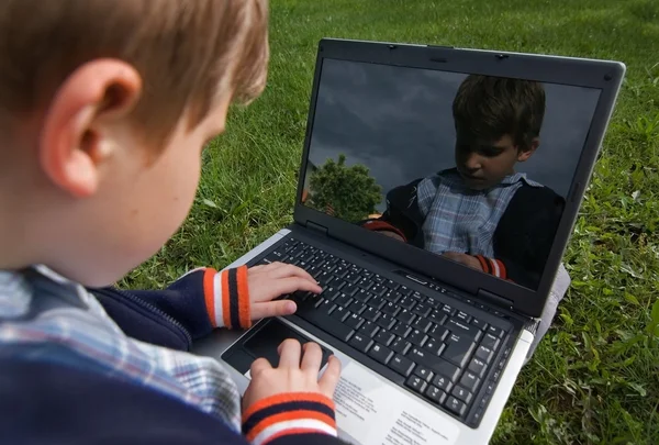 Young boy with notebook outdoor — Stock Photo, Image