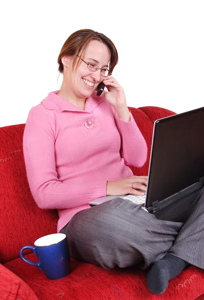 Cheerful woman with laptop on couch — Stock Photo, Image