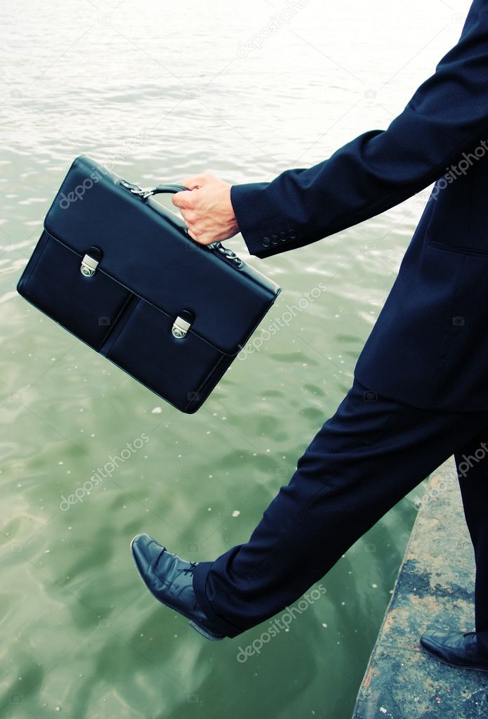 Business men step into the river