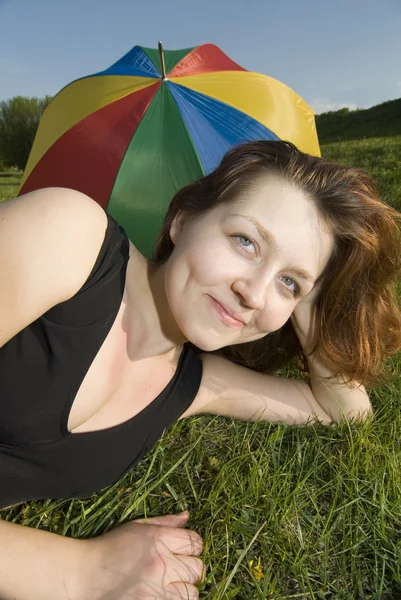 On a grass with umbrella — Stock Photo, Image