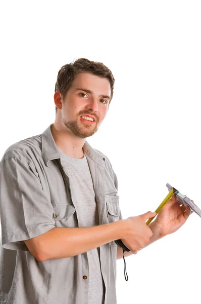 Young man measuring pack of cash — Stock Photo, Image