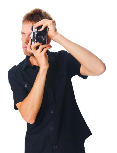 Young man with camera on white — Stock Photo, Image