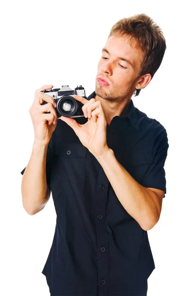 Mladý muž s kamerou na bílém pozadí — Stock fotografie