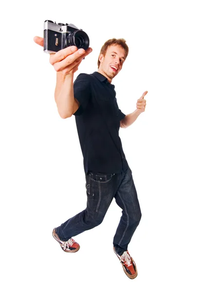 Young man with camera on white — Stock Photo, Image