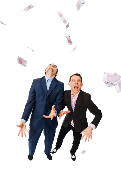 Uomini d'affari allegri che vomitano un mucchio di euro — Foto Stock