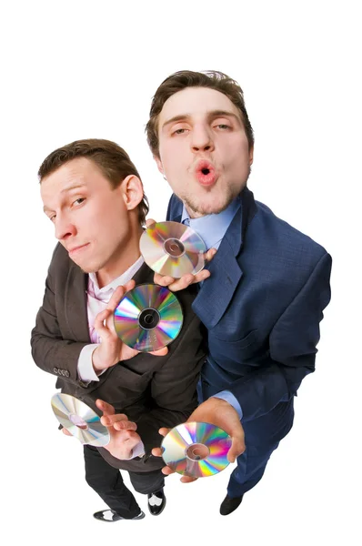 Dos hombres de negocios alegres que ofrecen DVDs a la venta — Foto de Stock