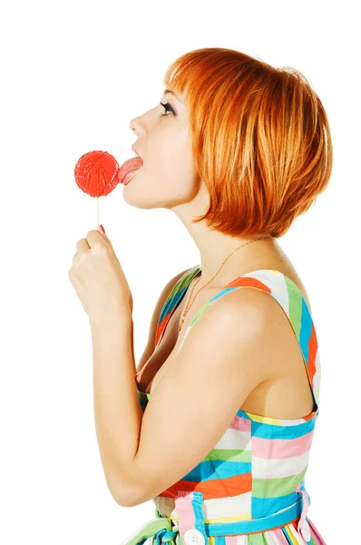 Menina vermelha bonita com doces — Fotografia de Stock