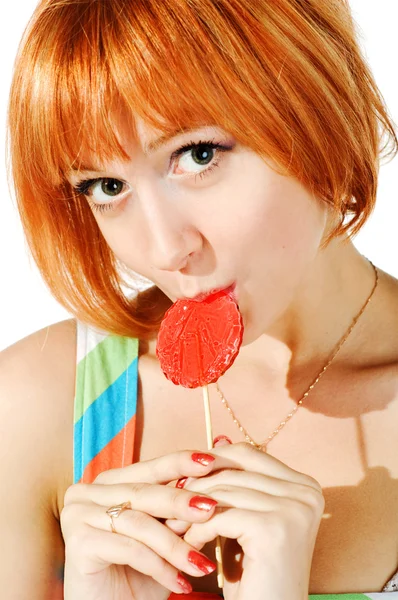 Menina vermelha bonita com doces — Fotografia de Stock